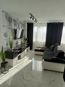 a living room with a couch and a table at APARTAMENT KOSMOS GORZOW in Gorzów Wielkopolski