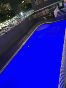 an overhead view of a large blue pool at night at Ocean Pearl in San Juan