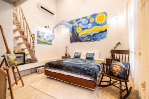 a bedroom with a bed and a painting on the wall at Silsopa Hostel in Nong Khai