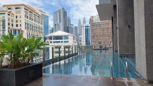 a view of a city skyline from a building with a pool at Anggun Presidential Suites in Kuala Lumpur