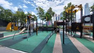 a playground with a slide and slides on a green at Anggun Presidential Suites in Kuala Lumpur