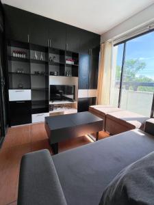 a living room with a couch and a table at Modern 2BR Condo Near SM with Free Parking Pool WIFI and Netflix in Davao City