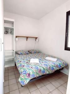 a small bedroom with a bed with avisor at T3 vue mer exceptionnelle in Six-Fours-les-Plages
