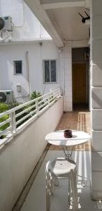 a white table and two chairs on a balcony at Innsite Room Rentals in Manila