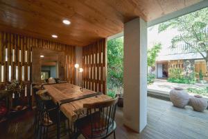 a dining room with a wooden table and chairs at Scenery after Rain in Yangyang