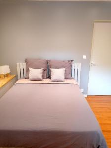 a large white bed with two pillows on it at Appartement paisible entre terre et mer in Cabrières