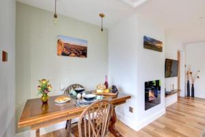 a dining room with a table and chairs and a fireplace at Sunset View a quiet and romantic rural retreat for 2 adults just outside ingleton in Ingleton 