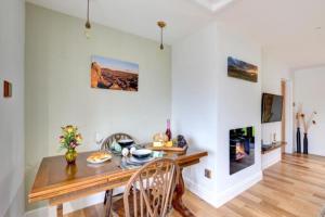 a dining room with a table and chairs and a fireplace at Sunset View a quiet and romantic rural retreat for 2 adults just outside ingleton in Ingleton