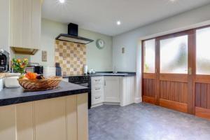 a kitchen with a counter and a bowl of fruit on a counter sidx sidx sidx at Sunset View a quiet and romantic rural retreat for 2 adults just outside ingleton in Ingleton 