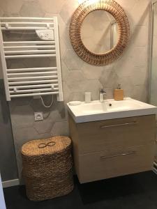 a bathroom with a sink and a mirror at Le Petit Nid d'Honfleur in Honfleur