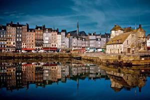 a group of buildings next to a body of water at Le Petit Nid d'Honfleur in Honfleur