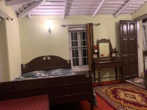 En eller flere senger på et rom på Rose Villa Heritage Bungalow No 9