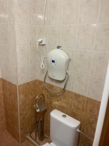 a bathroom with a toilet with a blow dryer on the wall at Borovets Sequoia2 luxury Apartment in Borovets +23 photos