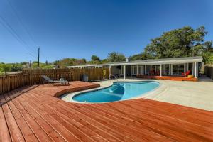 a swimming pool on a deck next to a house at New 5 BDRM W/Pool Mins to Pearl/Riverwalk/Quarry Market - Sleep 12 in San Antonio
