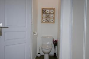 a white toilet in a bathroom with a door at CLOS DE LA BELLEVUE in Villes-sur-Auzon