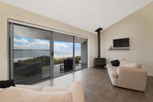 a living room with a view of the ocean at Seafarers Getaway in Apollo Bay