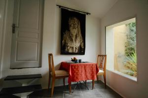 a dining room with a table and chairs and a picture at CLOS DE LA BELLEVUE in Villes-sur-Auzon