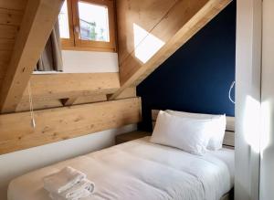 um pequeno quarto com uma cama num sótão em RELSTAY - Amendola em Milão