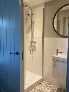 a bathroom with a shower and a toilet and a sink at Delightful self contained let in a village setting in Merston