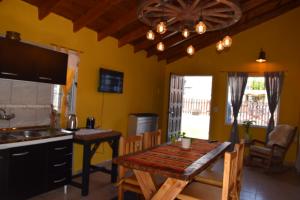 a kitchen with a table and a dining room at Casa Rural Bella Zaira in El Calafate