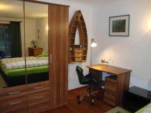 a bedroom with a desk and a bedroom with a bed at Haus Andreas in Kitzbühel
