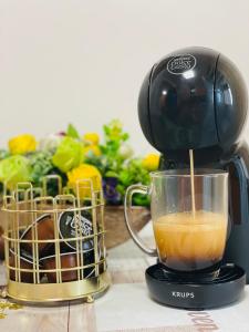 a mixer sitting on a counter with a cup of coffee at Imperium DK Apartament in Giurgiu