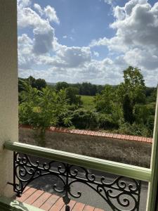 a bench sitting on a porch looking out at a garden at La Maison de Nicole in Mousseaux-sur-Seine