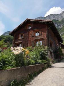 a brick house with flowers in front of it at Loft über dem Bodensee in Heiligenberg