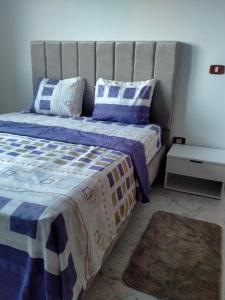 a bedroom with a bed with blue and white pillows at Bright two bedroom apartment Lac2 Tunis Tunisia in Tunis