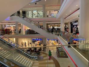 a shopping mall with escalators and people in it at Bright two bedroom apartment Lac2 Tunis Tunisia in Tunis