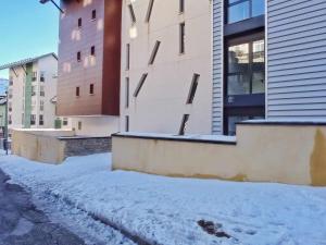 a snow covered street in front of some buildings at ESTUDIO LUNA in Sierra Nevada