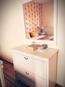 a dresser with a mirror on top of it at Village House Grevena in Grevena