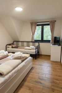 a room with four beds and a television in it at Chata Viola in Dolní Morava