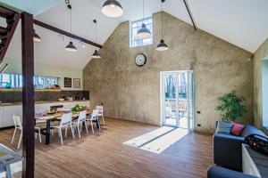 a kitchen and living room with a table and chairs at Marupes pirts in Mārupe