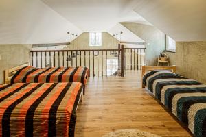 a room with two beds and a staircase at Marupes pirts in Mārupe