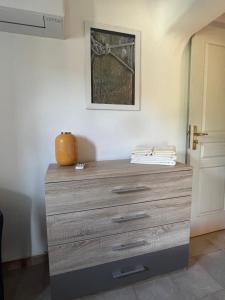 a dresser with a pumpkin sitting on top of it at Chambres et tables d'hôtes Zélia & Jacques BERQUEZ in Pianottoli-Caldarello