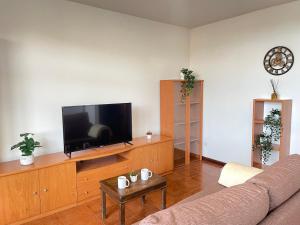 a living room with a couch and a flat screen tv at Apartamento a pie de playa en Mogro in Mogro