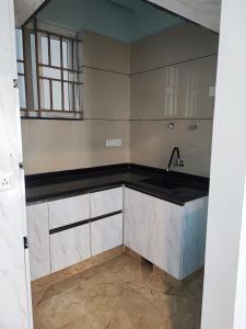 an empty kitchen with a sink and a window at Kamadhenu Residency Homestay Hotel Coorg Madikeri in Madikeri