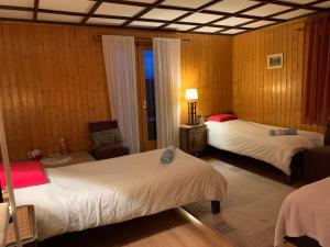 a hotel room with two beds and a chair at La Cure de Vernamiège in Vernamiège