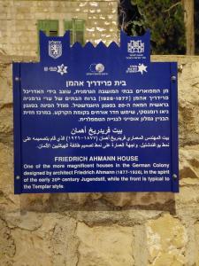 a blue sign on the side of a building at LEGATIA in the German Colony in Jerusalem
