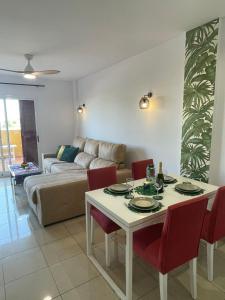 ein Wohnzimmer mit einem Tisch und einem Sofa in der Unterkunft Casa Palmera - El Bosque - Playa Flamenca in Playa Flamenca