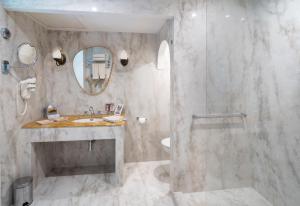 a bathroom with a shower and a sink and a mirror at La Magdeleine - Mathias Dandine in Gémenos