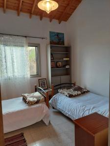 um quarto com 2 camas individuais e uma janela em Veranda em Agros
