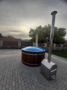 a hot tub and a television on a patio at JóKissHely Vendégház in Erdőbénye