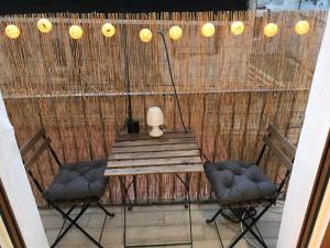 a table and chairs on a patio with lights at Apartamento centro Santander B in Santander
