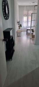 a white room with a table and a mirror on the wall at PETIT Home in Alcalá de Henares