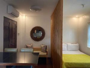 Habitación de hotel con cama y espejo en Pensio de Felipe en Tagaytay
