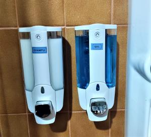two white and blue blasters hanging on a wall at Casa Rural EL HUERTO con Jardín in Lumbrales