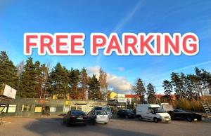 a sign that says free parking in a parking lot at Arkadia Hotel & Hostel in Helsinki