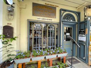a store front with flowers in front of it at Central Old Town Cottage in Bangkok